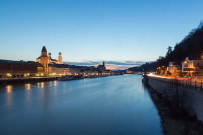 River passing through city at dusk