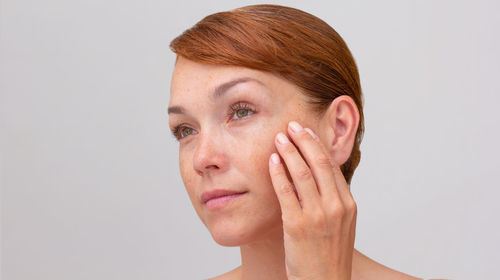 Close-up of woman against white background