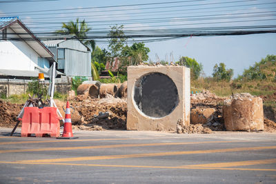 Built structure by road against sky in city