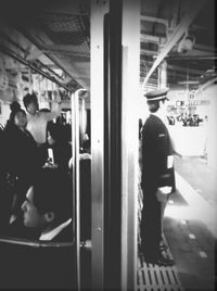 Rear view of woman standing at railroad station platform