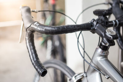 Close-up of bicycle parked against wall