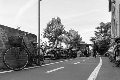 Bicycles on road against buildings
