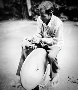 Man sitting on road