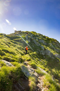 Low angle view of man standing on mountain at negoiu peak