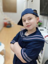 Portrait of boy standing at home