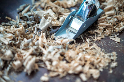 Wood shavings working with a metal spokeshave and wood flakes.