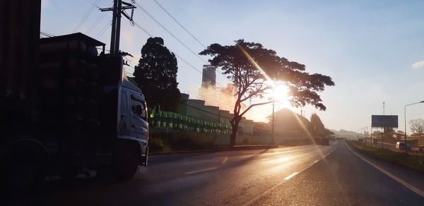 Cars on road in city against sky