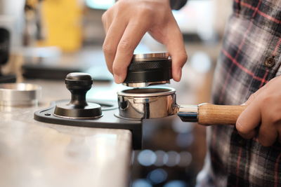 Barista making coffee at cafe