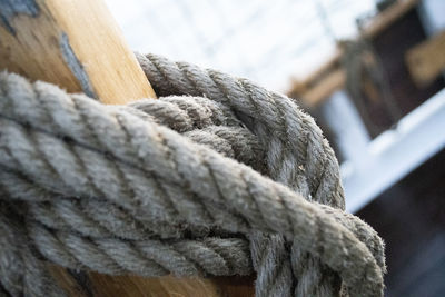 Close-up of rope tied up on wood