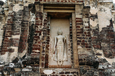 Statue against historic building