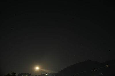 Low angle view of silhouette trees against sky at night