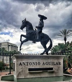 Low angle view of statue against cloudy sky