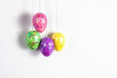 Close-up of multi colored candies against white background