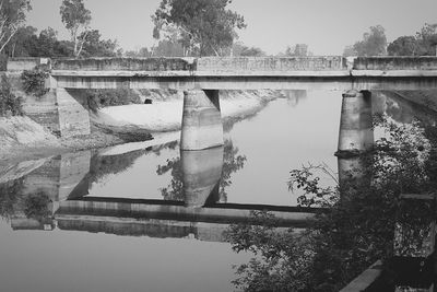 Bridge over river with buildings in background