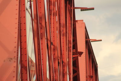 Low angle view of red construction site against sky