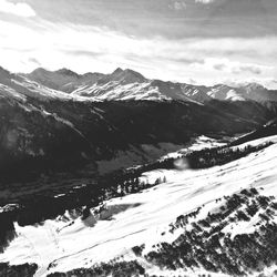 Scenic view of mountains against cloudy sky