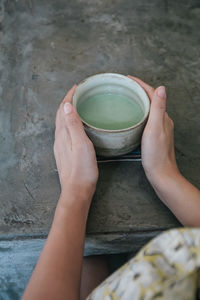 Cropped image of woman hand holding tea cup