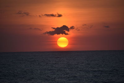 Scenic view of sea against romantic sky at sunset