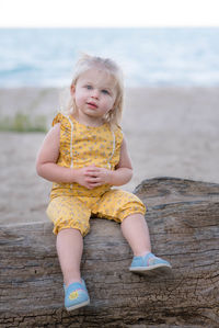 Full length of a girl sitting on beach