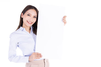 Portrait of a smiling young woman over white background