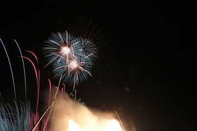 Low angle view of firework display at night