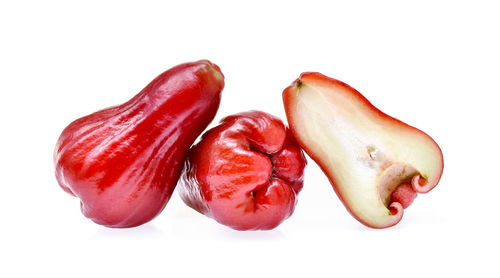 Red fruits over white background