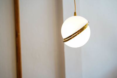 Low angle view of light bulb hanging from ceiling