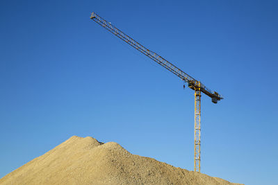 Germany, bavaria, munich, construction crane against blue sky