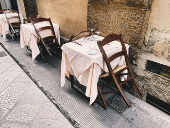 High angle view of chairs on table against wall