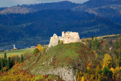 Built structure on landscape against mountain range