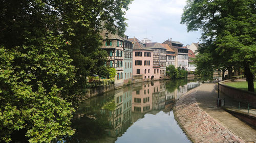 Canal amidst buildings against sky