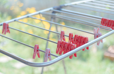 Close-up of clothespins on rack