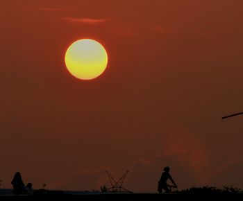 Silhouette of people at sunset