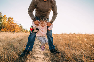 Father and child having fun playing outdoors. dad and daughter spending time together, relaxing 