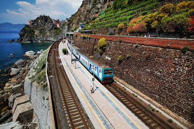 Train on railroad tracks by sea