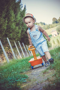 Baby boy pulling trolley