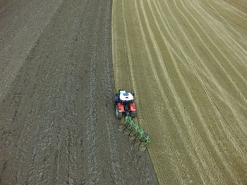 Aerial view of tractor plowing field