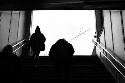 Rear view of silhouette people walking on stairs