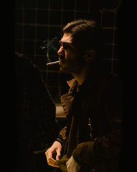 Young man smoking cigarette