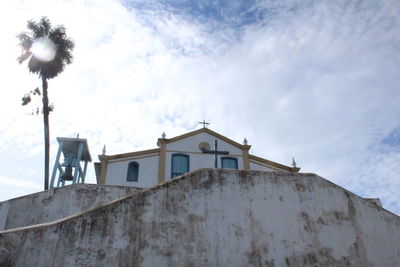Low angle view of building against cloudy sky