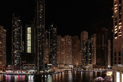 Illuminated buildings in city at night