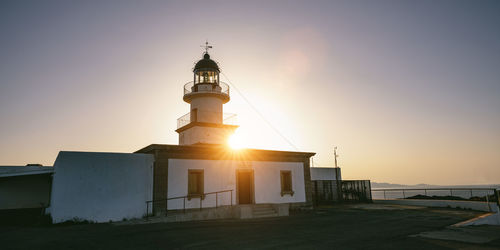 Low angle view of lighthouse against sky during sunset