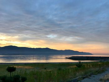 Scenic view of beach against sky during sunset