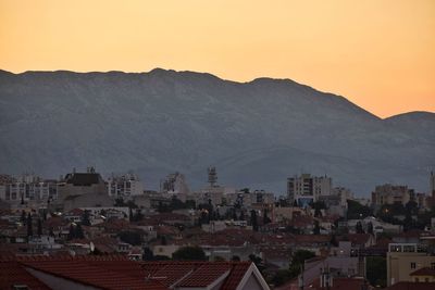 Aerial view of townscape against sky during sunset