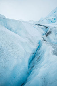 Glacier against cloudy sky