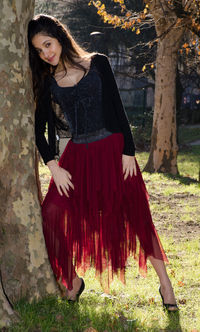 Portrait of beautiful woman standing in park