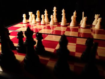 Close-up of chess pieces against black background