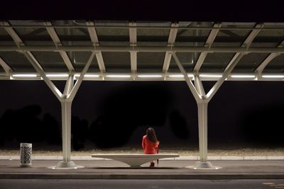 Rear view of woman standing at night