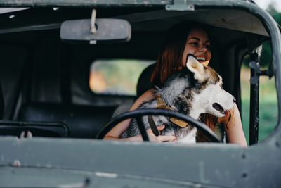 Portrait of young woman sitting in car