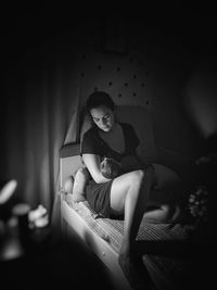 Portrait of young woman sitting at home